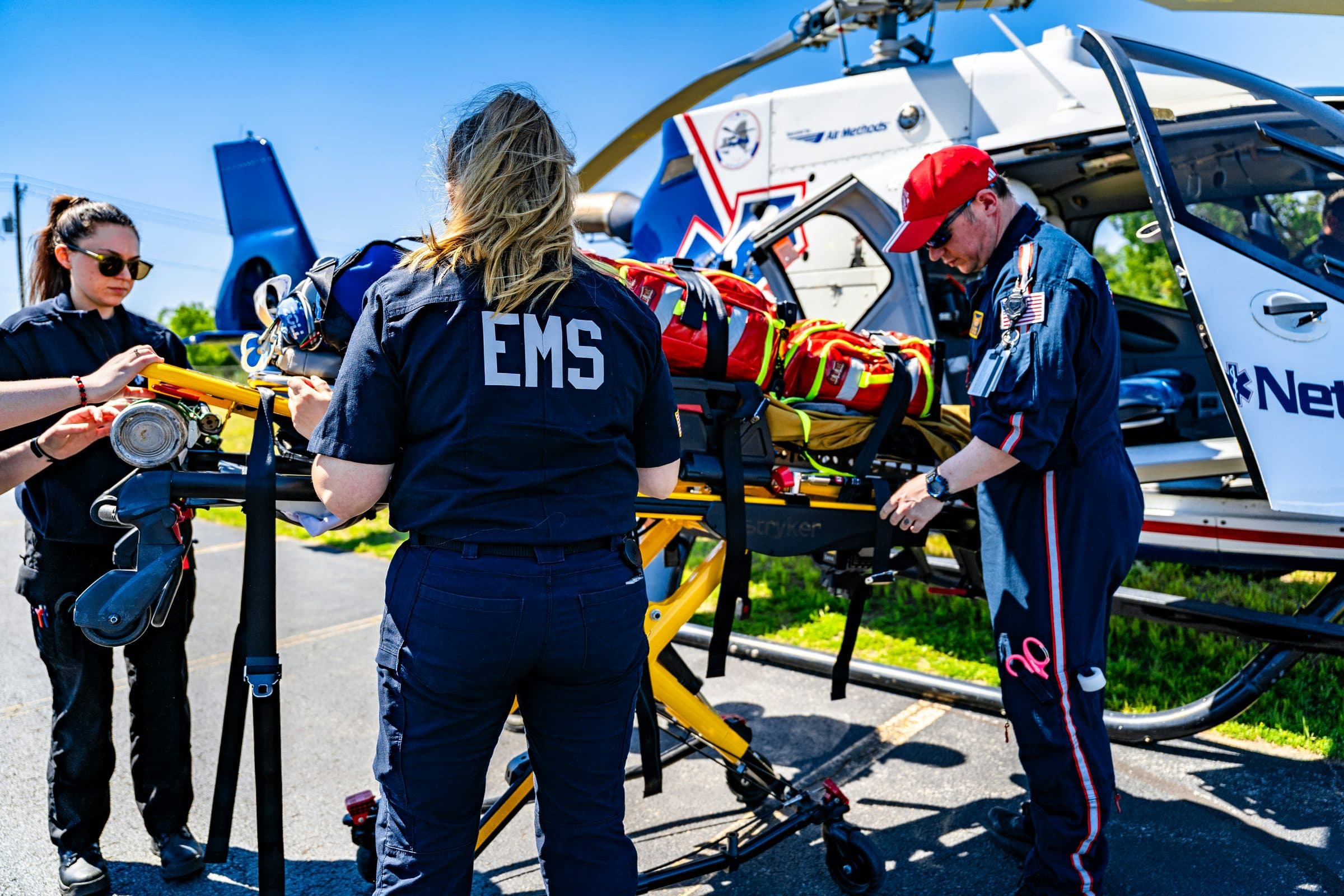 An EMS crew loading a patient onto an air ambulance