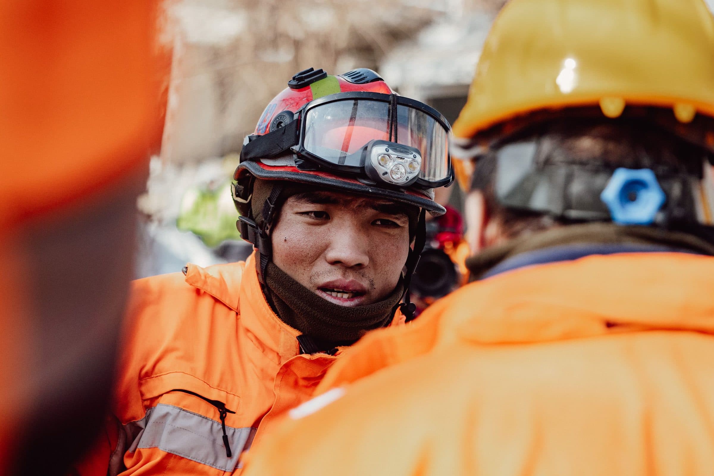 A search and rescue responder in high-visibility gear at a scene
