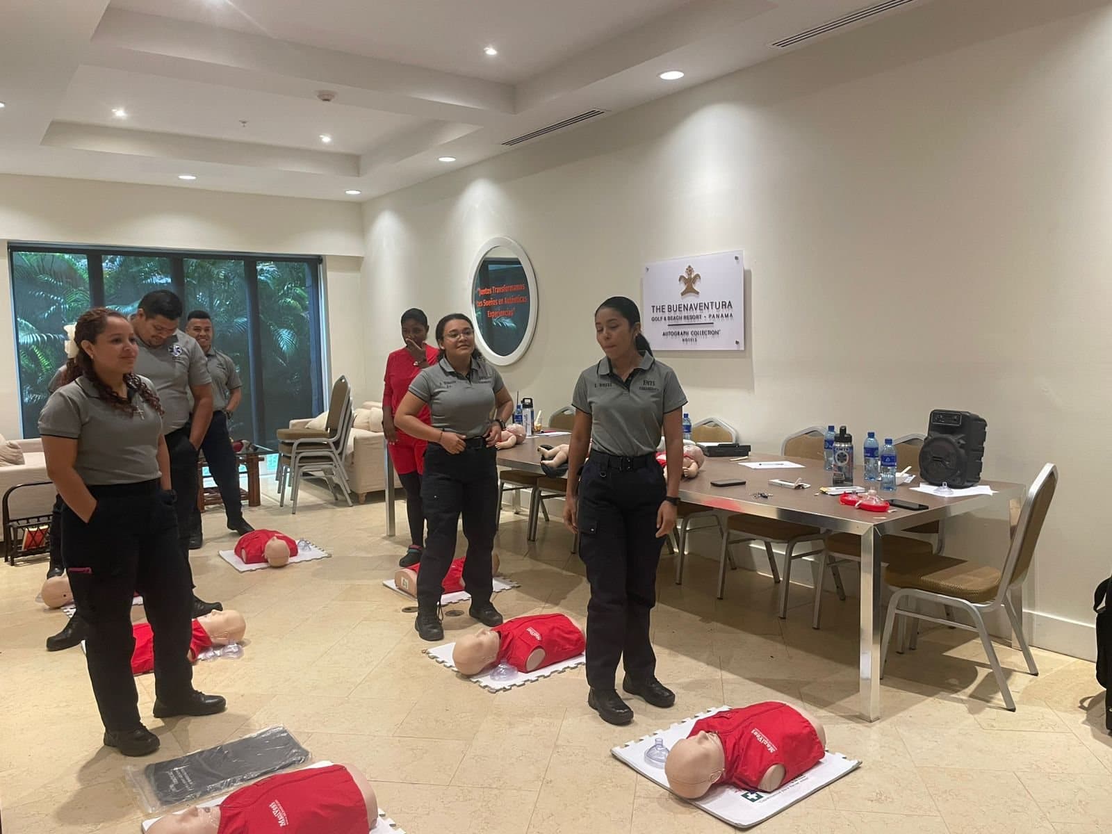 A classroom of students working around CPR manikins in Panama