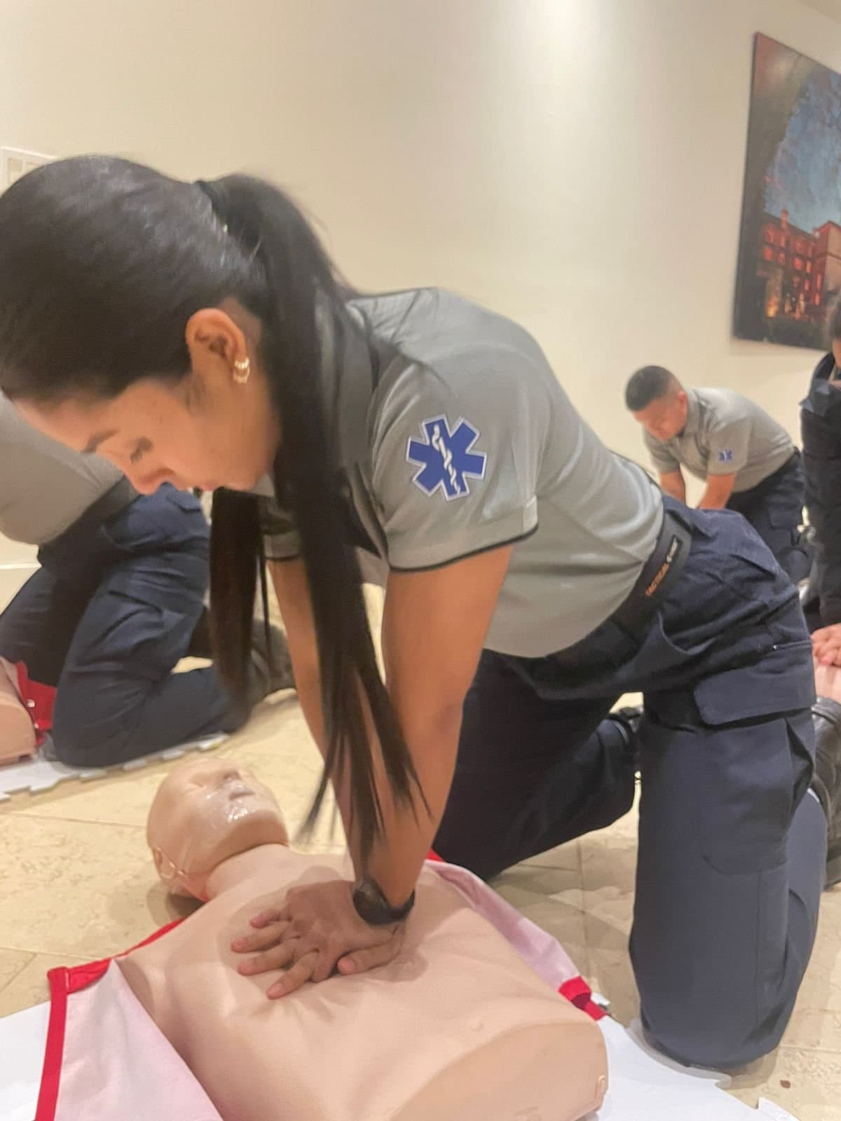 A Panamanian medic performing chest compressions on a training manikin